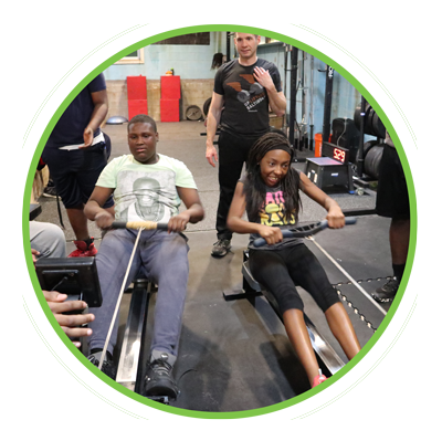 Two teens using rowing machines