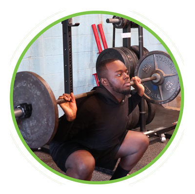 A young man doing back squats